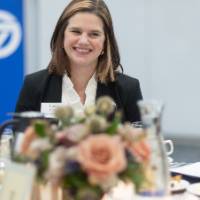 Laura Aikens smiling at others seated at her table